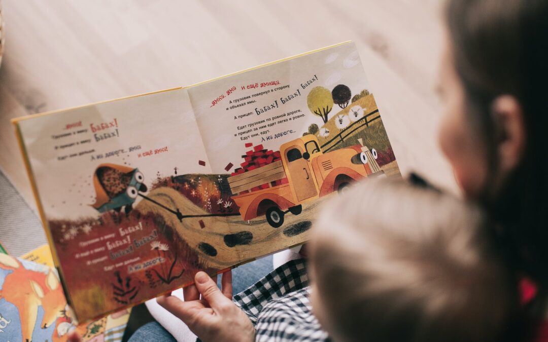 woman reading book to toddler